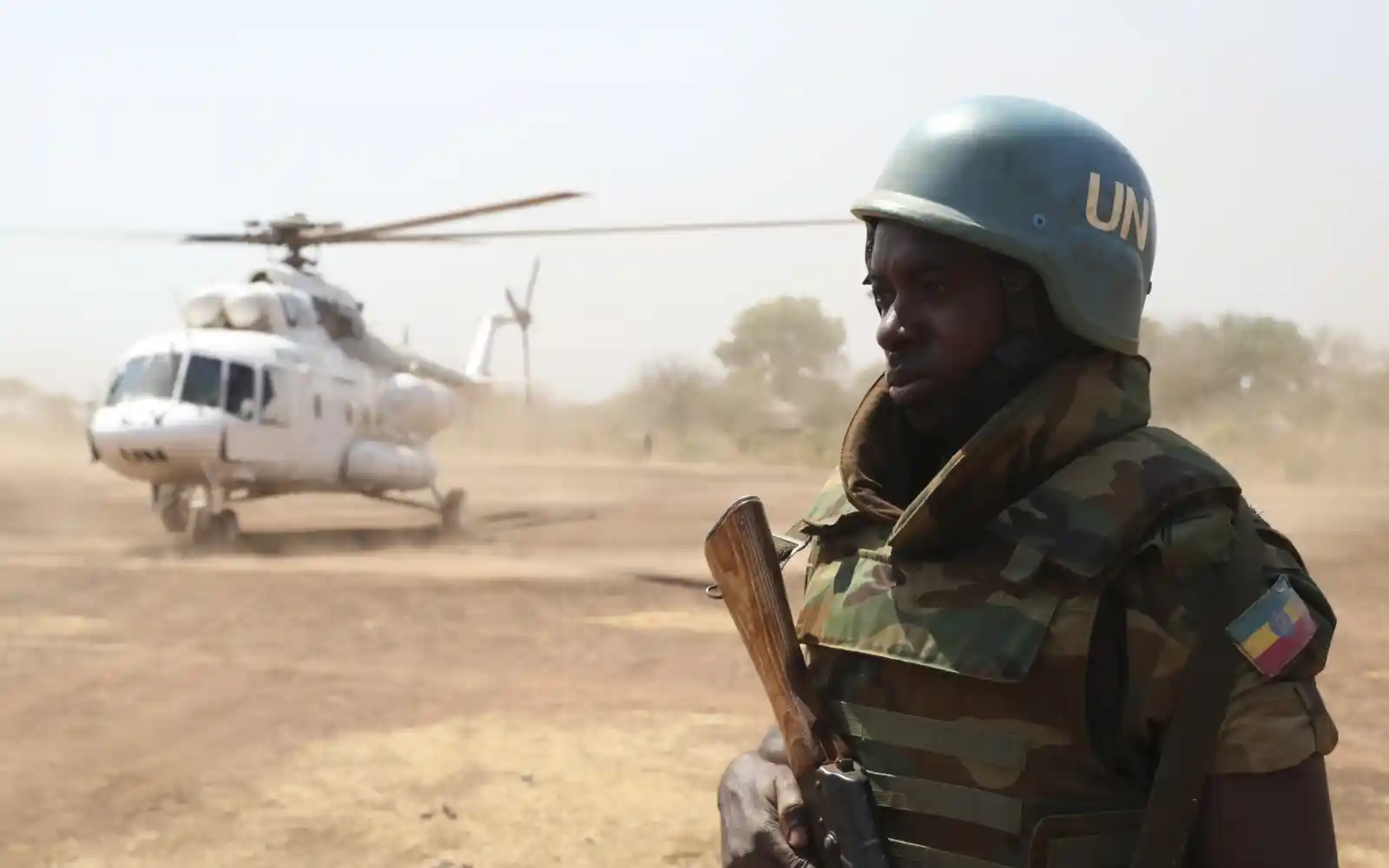 An Ethiopian peacekeeper serving with the United Nations Mission in South Sudan (UNMISS), stands guard near an UNMISS helicopter at an airbase in Mundri.