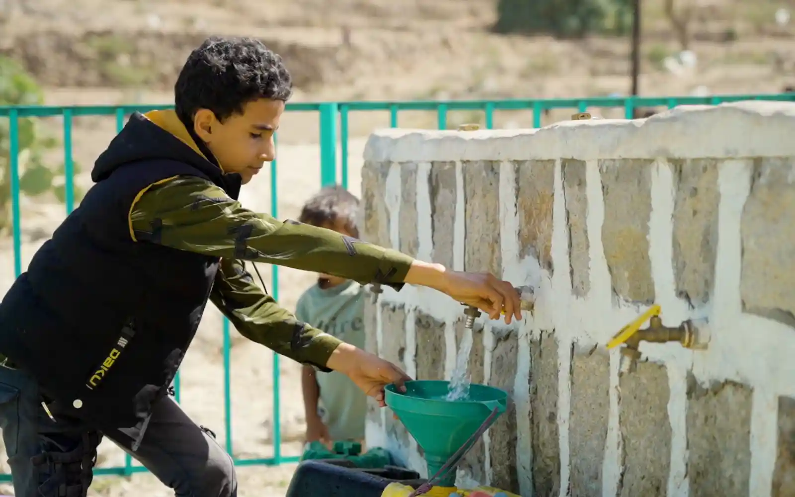 In Dhamar, Yemen, a boy fetches water from a solarized water well.