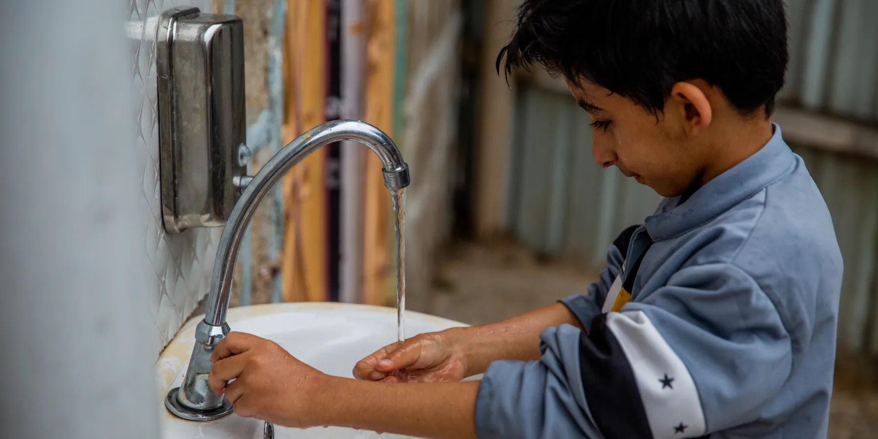 A child in Badan District, Ibb governorate uses running water in his house. The water well is powered by solar energy.