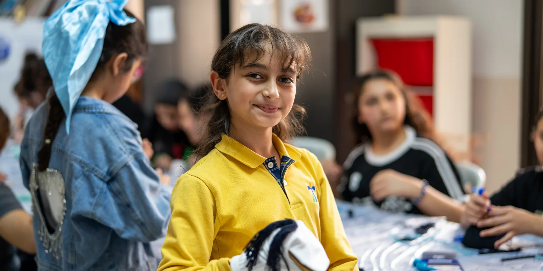 Children take part in a puppet making activity in Beirut to help with trauma relief, organized by one of UNOPS implementing partners.
