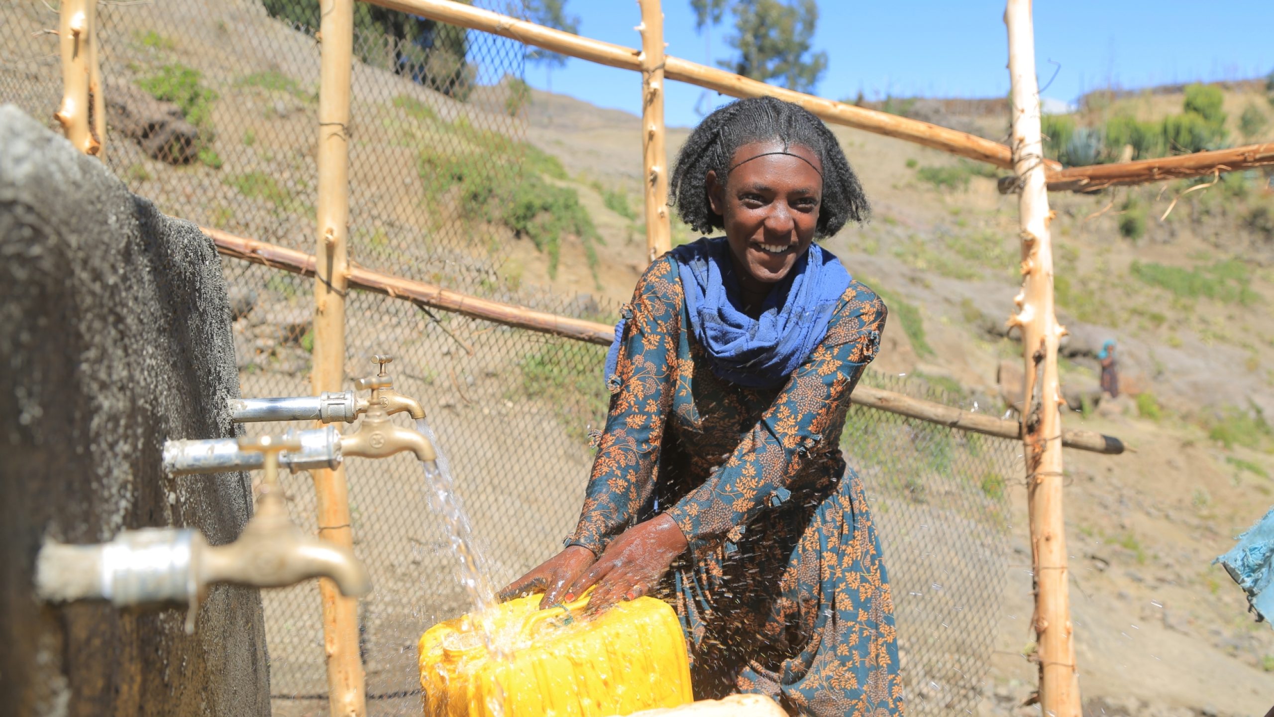 A woman uses a newly constructed water point in Tigray, Ethiopia