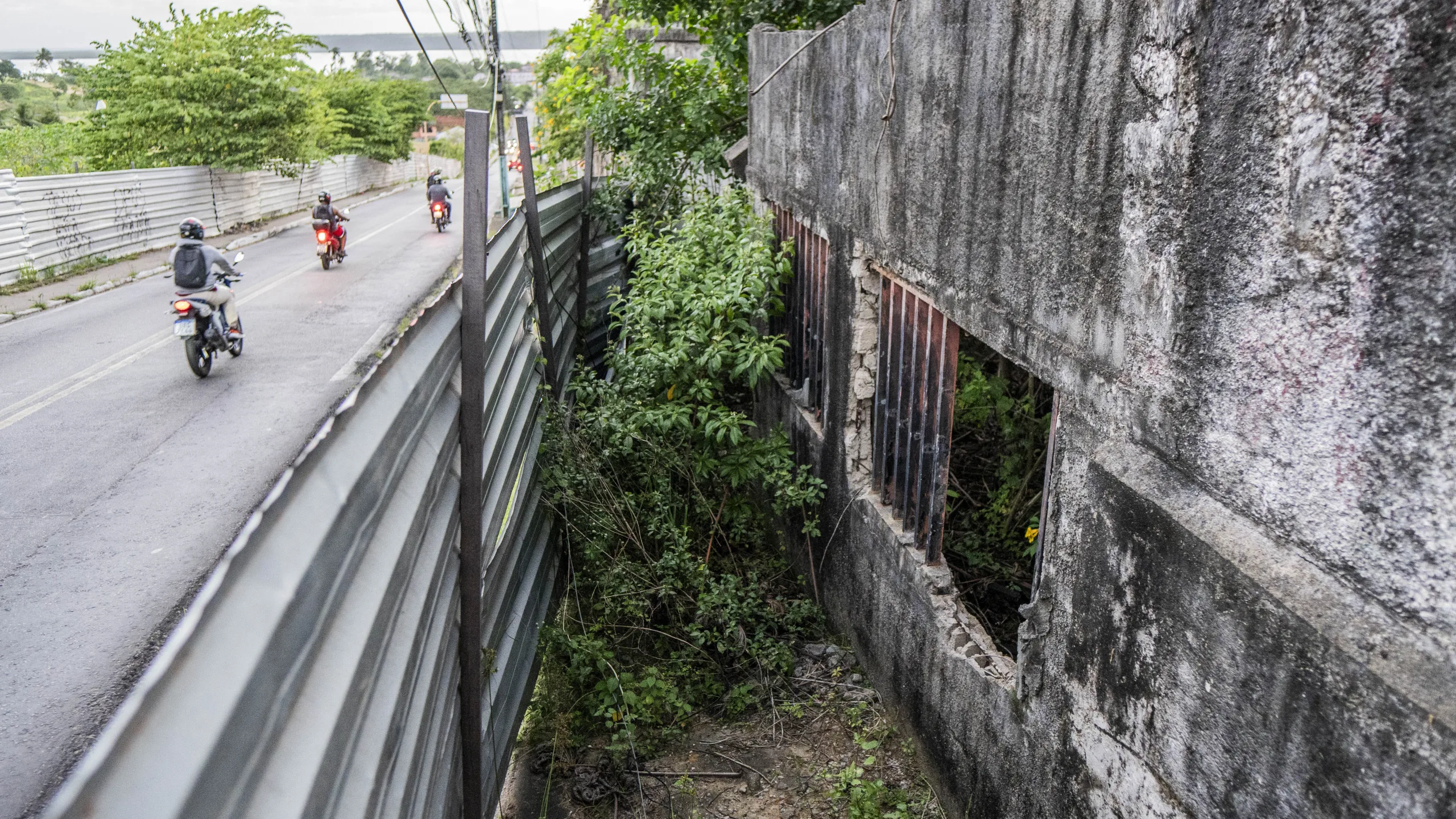 Metal containment fences line the perimeter of the disaster zone
