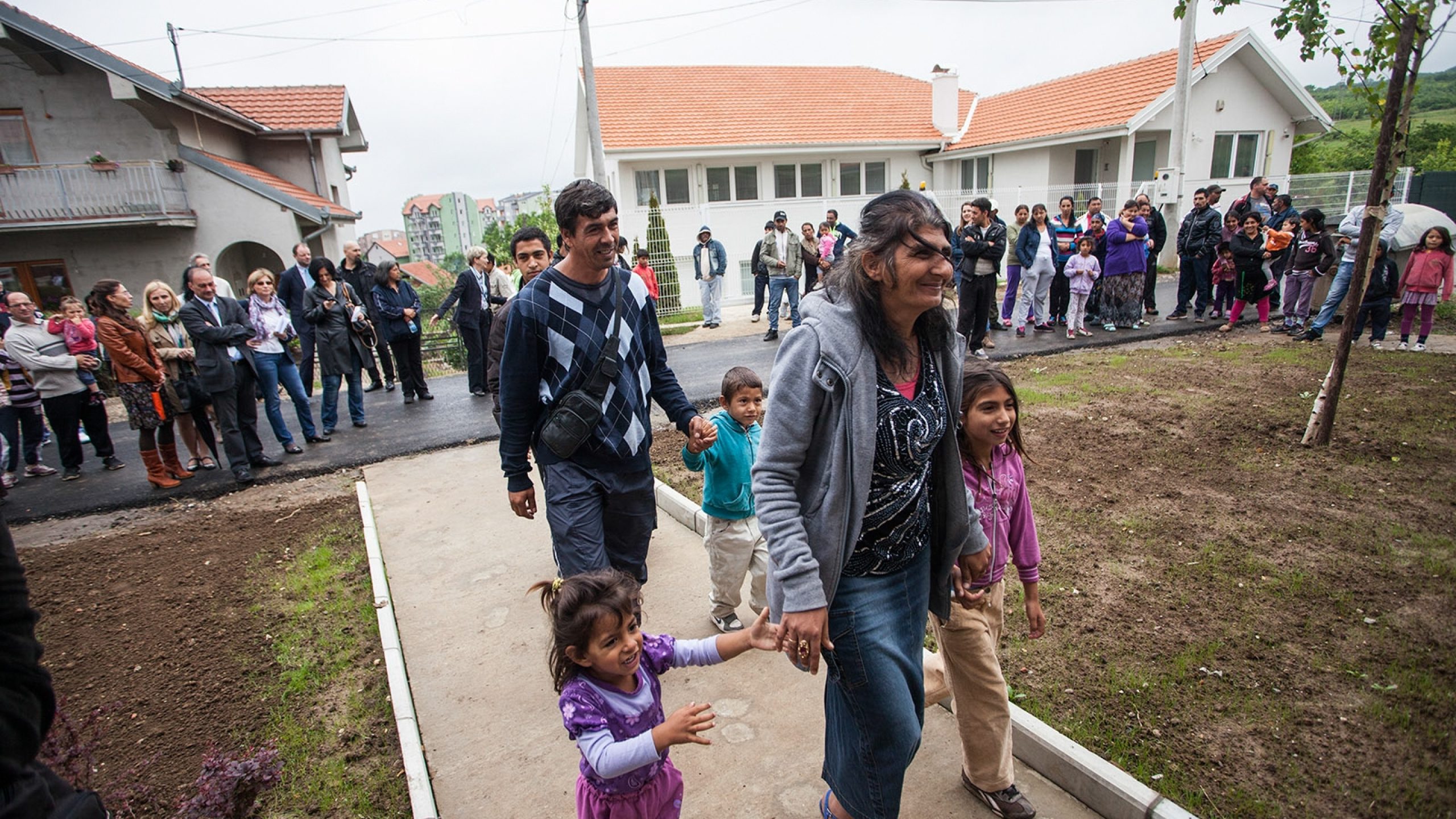 A previously displaced community moves into permanent homes.