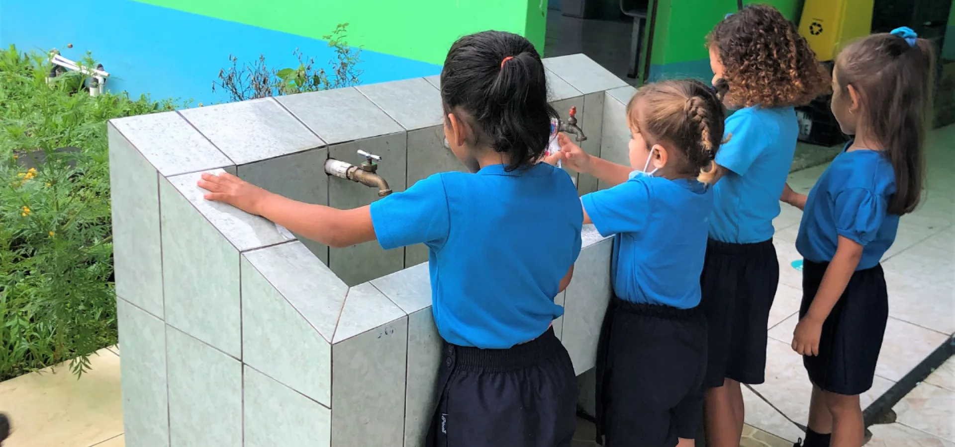 Young children make use of proper water and sanitation services at a school in Costa Rica.