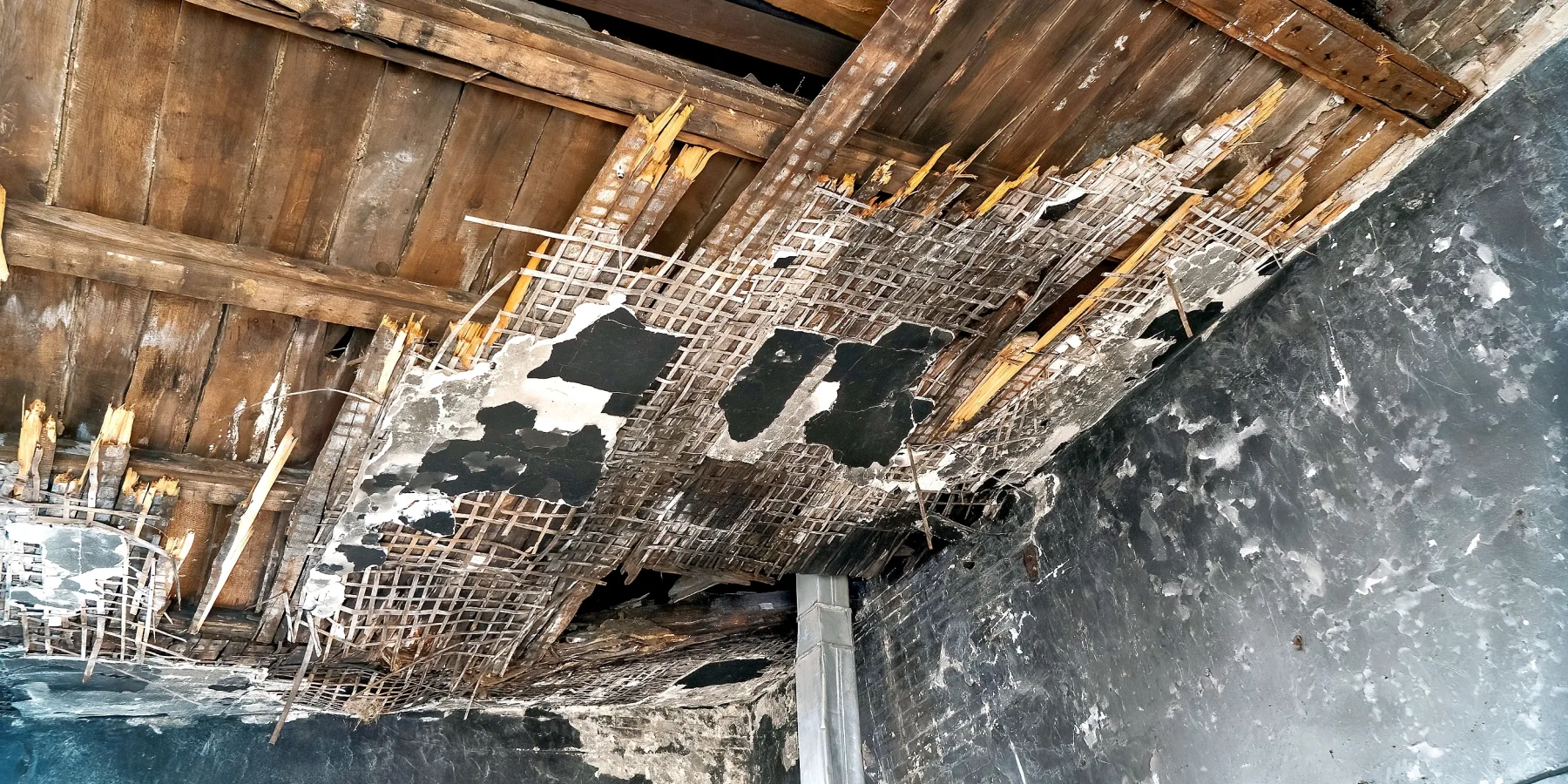 A fire-damaged ceiling in one of the college's rooms before repairs were undertaken. The renovation work focused on the rooms that had suffered the most from the fires.