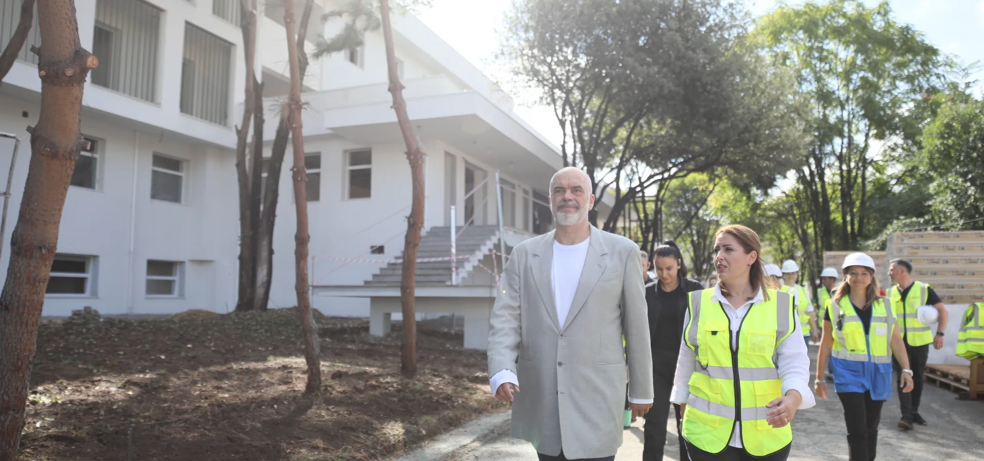 President of the Republic of Albania walks with Ogerta Manastirliu, Minister of Health and Social Protection, during a site visit.