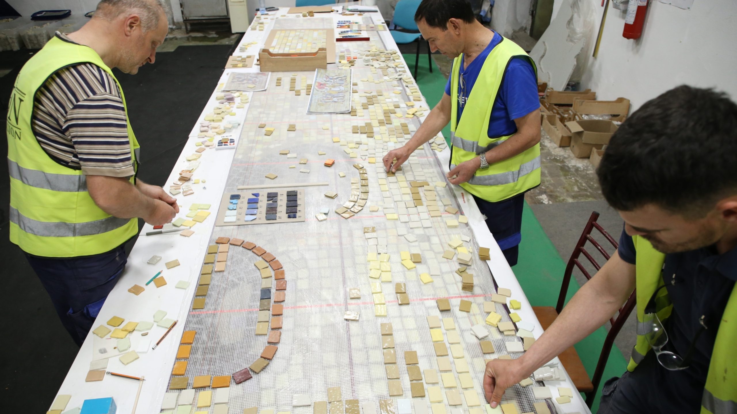 EU4Culture experts examine the mosaic pieces.