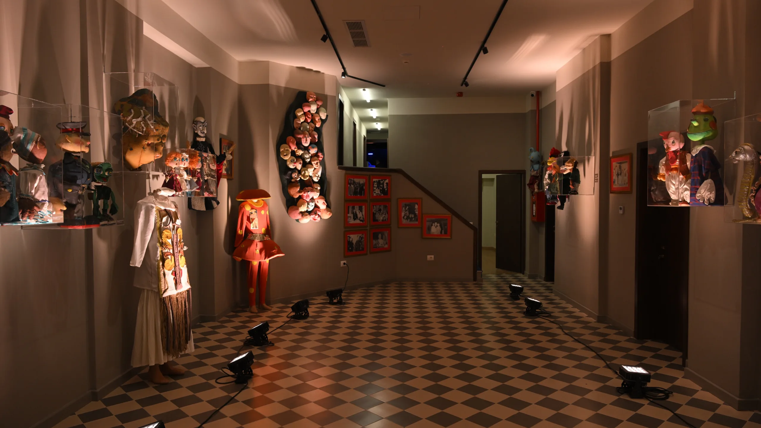 The entrance of the Puppet Theatre showcases a vibrant display of puppets, costumes, and historical photographs, celebrating decades of creativity and storytelling.