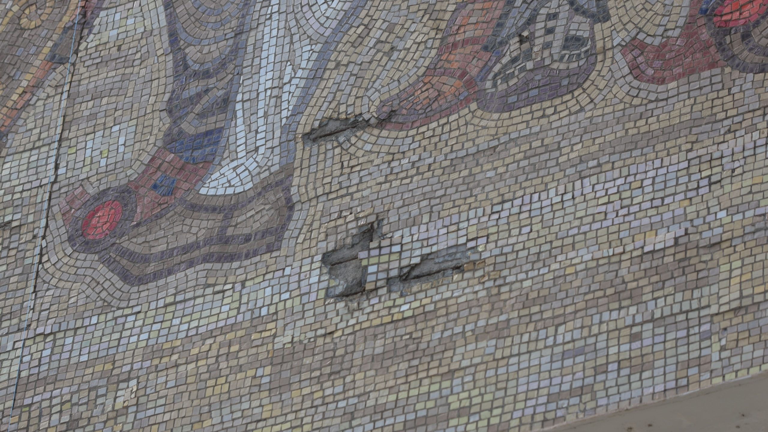 Damage to the mosaic.