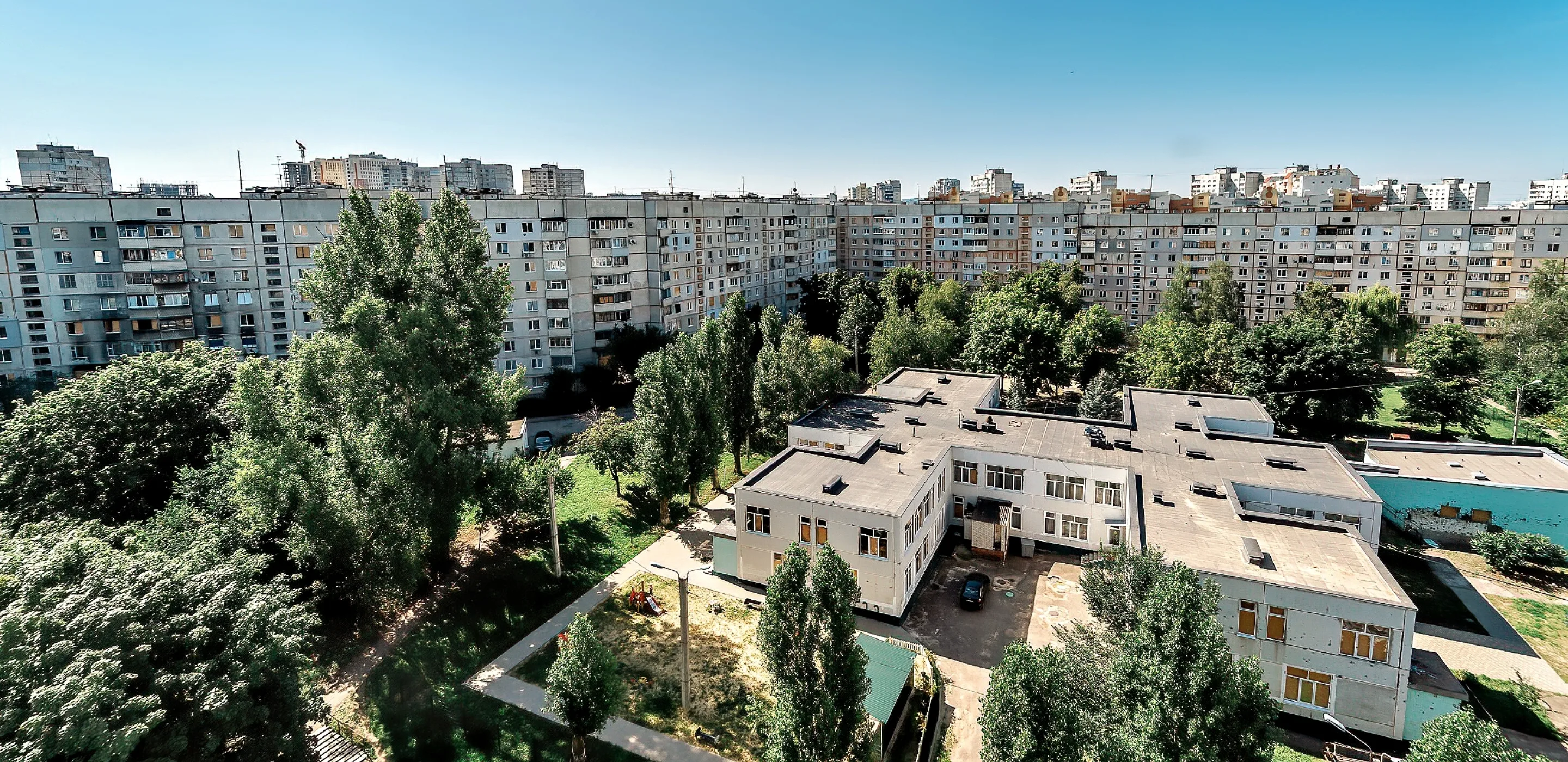The landscape of Saltivka, with a kindergarten (foreground) and residential buildings.