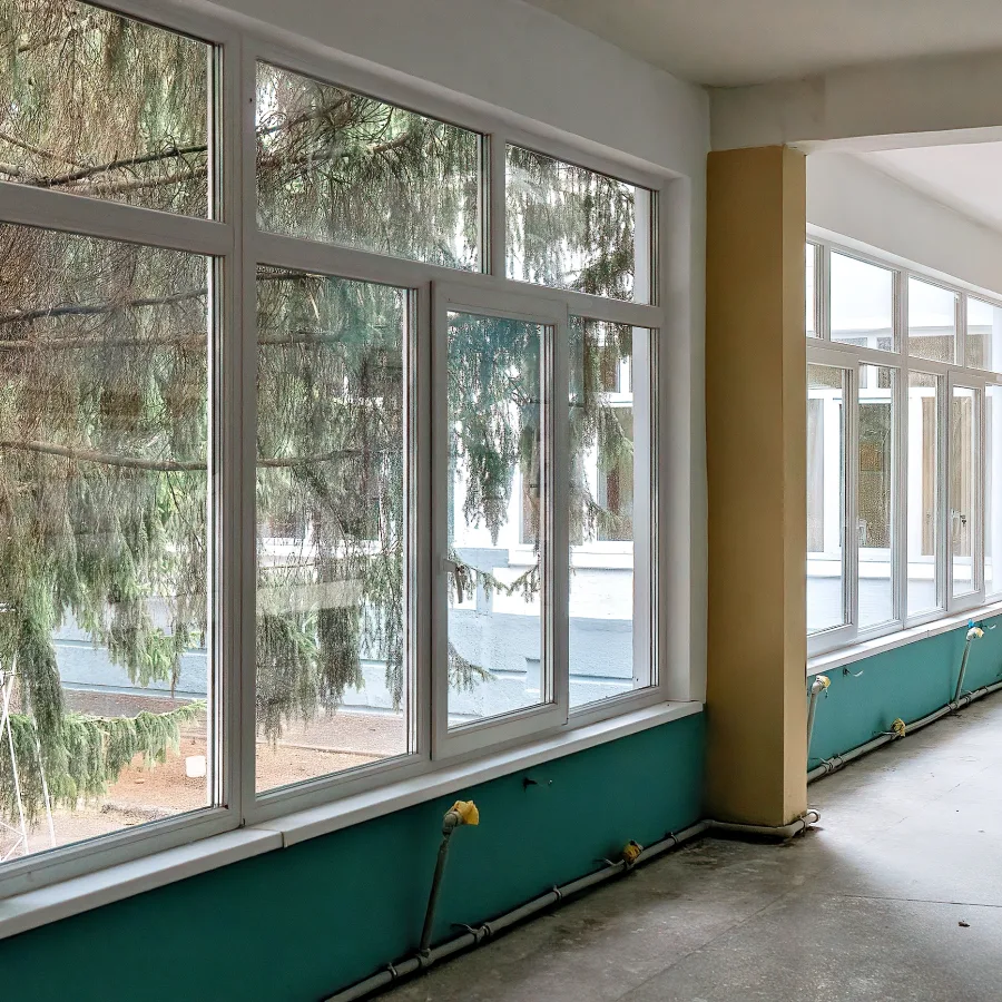Before and after photos of the school corridor, which has been completely renovated, with new windows installed and additional work completed