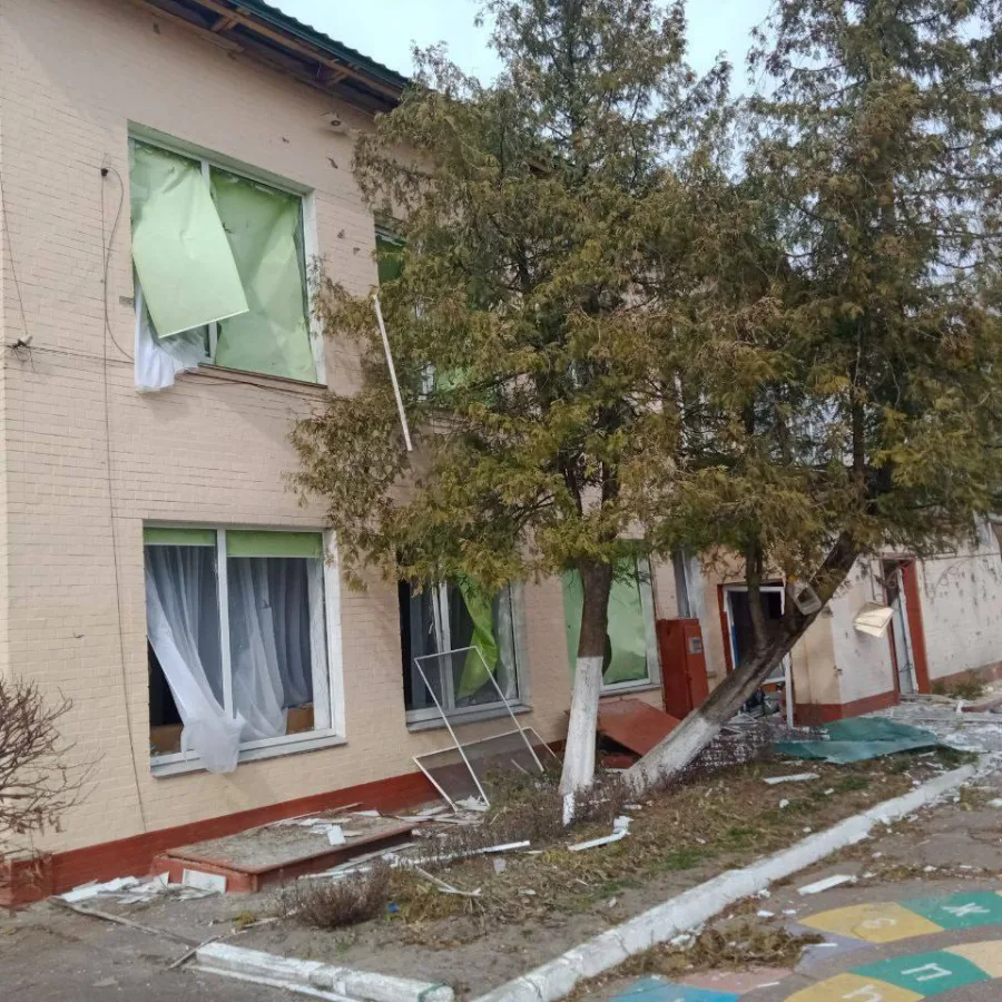 The building's exterior, with windows blown out and debris scattered across the grounds, reveals the extensive damage that made the preschool unsafe for children.