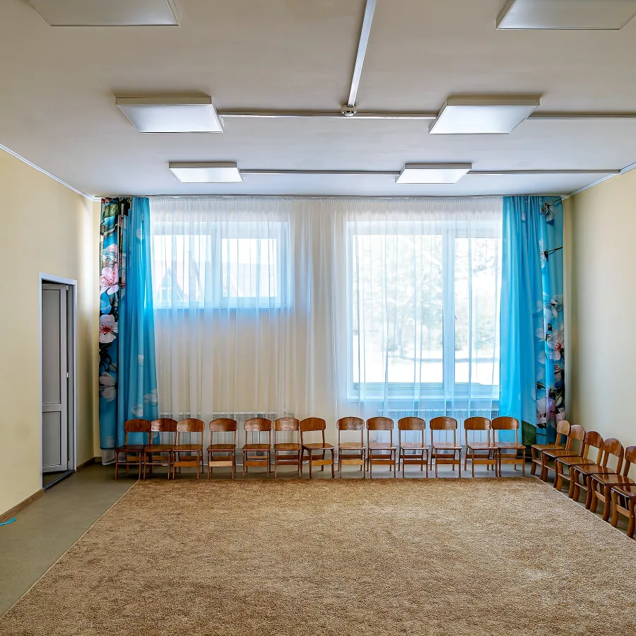 The newly repaired assembly hall, with its clean floors, bright lighting, and neat rows of chairs, stands ready for school events, performances, and gatherings.