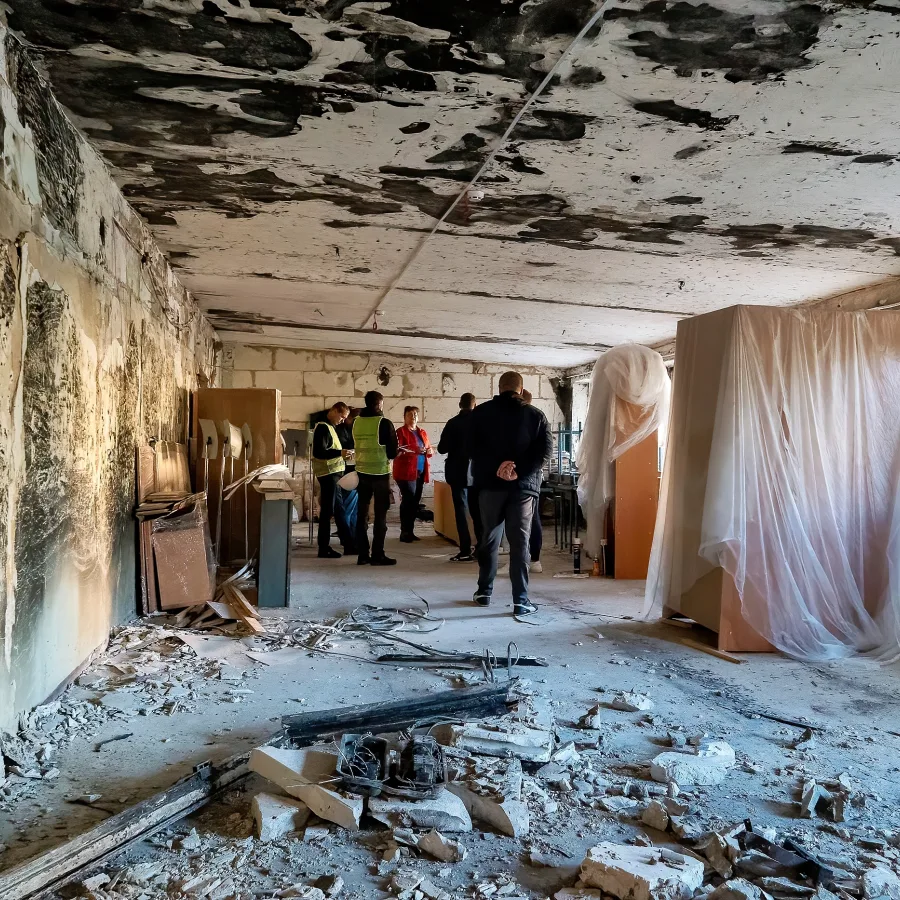 An inspection of one of the college workshops damaged by fire at the beginning of the war.
